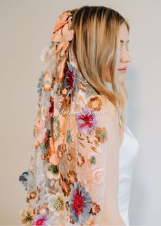 a woman wearing a veil with flowers on it