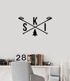 the wall decal is decorated with arrows and skis in black on a white background