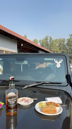 a table with food and drinks on it in front of a truck