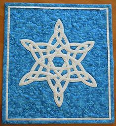 a blue and white quilt with a star on it