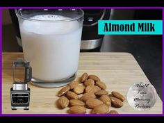 almonds and milk on a cutting board next to a blender with the words almond milk