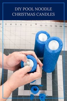 someone is decorating some candles on a table with blue felt and white cotton yarn