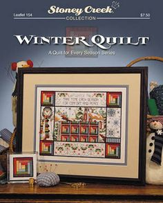 the winter quilt pattern is displayed in front of a table with other items on it