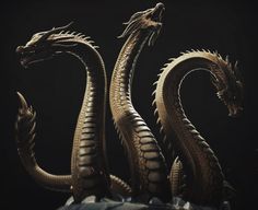 a close up of a dragon statue on a black background