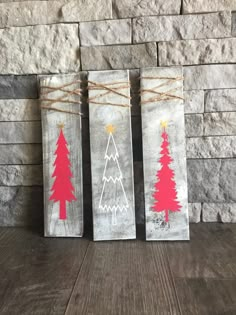 three christmas trees painted on wood with twine