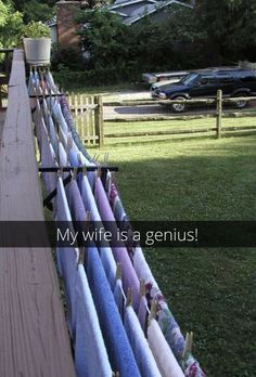 a fence that has some towels hanging on it and the words, my wife is a genius