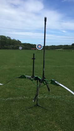 two arrows are in the middle of a field with an arrow and target on it