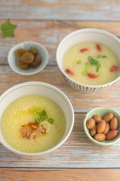 three bowls filled with food sitting on top of a wooden table next to each other