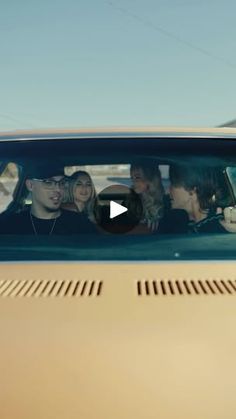 a group of people sitting in the passenger seat of a car with their heads sticking out