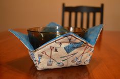 an origami bowl sitting on top of a wooden table