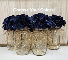 four mason jars with blue flowers in them and the words choose your colors on top