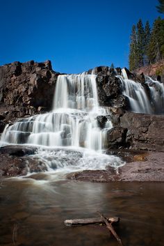 a large waterfall with water cascading down it's sides