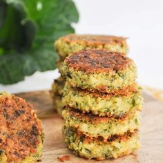 four crab cakes stacked on top of each other with leaves in the backgroud