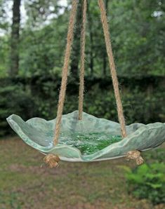 a glass hanging bowl filled with green liquid