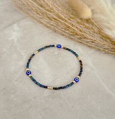 Evil Eye Bracelet - Evil Eye Jewelry - Blue Evil Eye Bracelet, Iridescent Blue Bracelet - Gold Filled Bracelet - Dainty Gold Bracelet - Stretchy Evil Eye Bracelet  * D E T A I L S * This bracelet is made with: Miyuki Seed Beads 14K Gold-filled beads Stretch Cord * Q U E S T I O N S * If you have any questions, please send me a message 🖤 Bracelet Or, Tiny Bead Bracelet, Bracelet Evil Eye, Dainty Gold Bracelet, Gold Armband, Iridescent Blue, Bracelet Dainty, Jewelry Blue, Blue Evil Eye