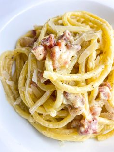 a white plate topped with pasta covered in sauce