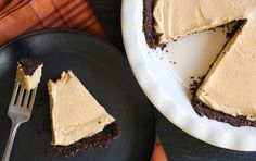 a piece of cake on a plate with a fork next to it and another slice missing