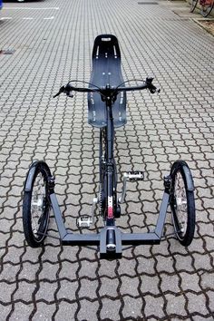 an electric scooter is parked on the pavement