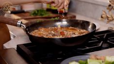 someone is cooking food in a pan on the stove