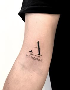 a person with a tattoo on their arm that says x and momvii in roman numerals