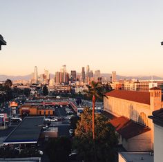 the city skyline is seen from an apartment building