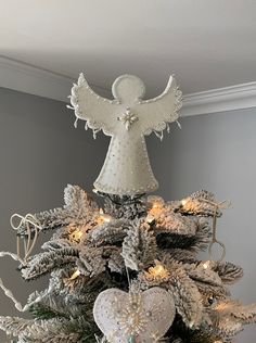 a white christmas tree decorated with angel ornaments