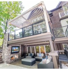 an outdoor living area with patio furniture and fireplace