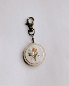 a key chain with a flower embroidered on it