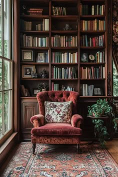 a red chair sitting in front of a book shelf filled with books