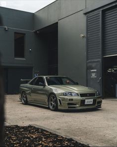 a silver car parked in front of a garage