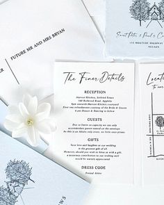 the wedding stationery is laid out on top of each other, with a white flower