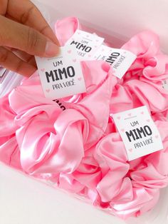 pink scrunffles in a plastic container with labels on them that say i am mmo