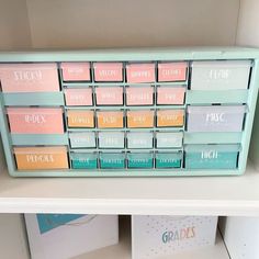 a shelf with many different colored labels on it's sides and some cards in the middle