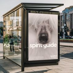 a poster on the side of a bus stop with a dog's face in it