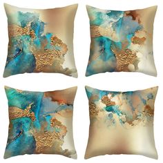 four decorative pillows with blue and gold designs