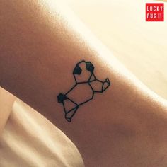 a small tattoo on the ankle of a woman's leg that has an origami dog on it