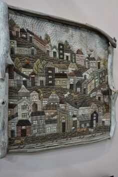 a wall hanging with a city scene on it