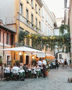 people sitting at tables in an outdoor cafe