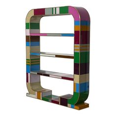 a multicolored wooden shelf sitting on top of a white wall