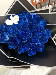 a bouquet of blue roses sitting on top of a table