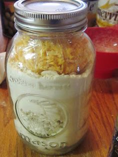 a jar filled with cereal sitting on top of a wooden table