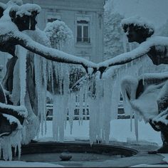 two statues are covered in ice and icicles