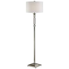 a floor lamp with a white shade on it