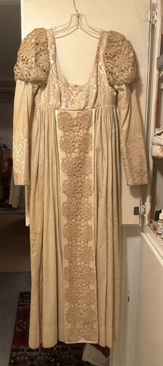 Traditional Beige Lace Dress, Traditional Wedding Dress With Historical Design, Vintage Gold Dresses With Historical Design, Gold Vintage Wedding Gown, Vintage Gold Dress With Historical Design, Vintage Gold Wedding Gown, Vintage Wedding Dresses With Intricate Embroidery, Traditional Floor-length Lace Gown, Vintage Brocade Victorian Dress