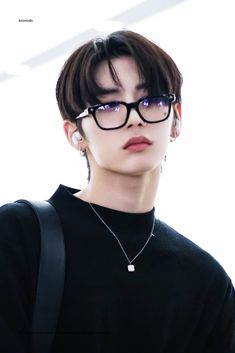 a person wearing glasses and a black shirt