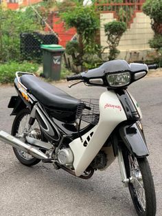 a white and black motorcycle parked on the street