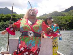 two women in colorful outfits on a boat