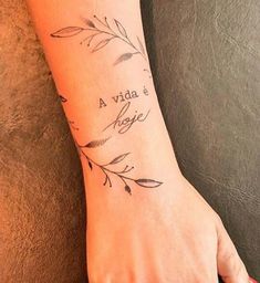 a woman's hand with a tattoo on it that reads, vida e magic