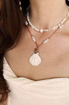 This Beach Days Shell Pendant Necklace Set features a beaded shell pendant, 2 piece set, and adjustable cord made with high-quality freshwater pearls. Perfect for adding a touch of ocean-inspired style to any outfit. 18kt gold plated brass freshwater pearl acrylic pearl shell wax cord set of 2 shell necklace: 30" adjustable cord beaded necklace: 15" with 5" extender Cheap Summer Shell Necklace As Gift, Cheap Blue Shell Necklace For Gift, Cheap Round Beads Shell Necklace For Vacation, Cheap Shell Necklaces With Round Beads, Cheap Handmade Shell Necklaces, Affordable Beachy Shell Necklace As A Gift, Cheap Shell Beaded Necklaces For Vacation, Cheap Shell Beaded Strand Necklace, Ablone Shell And Beaded Necklaces