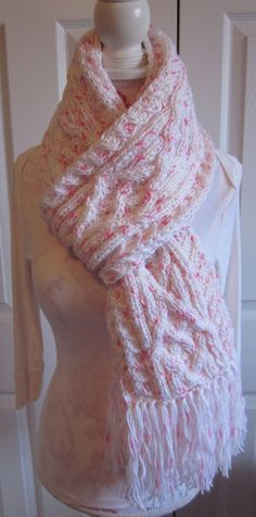 a white knitted scarf on top of a mannequin